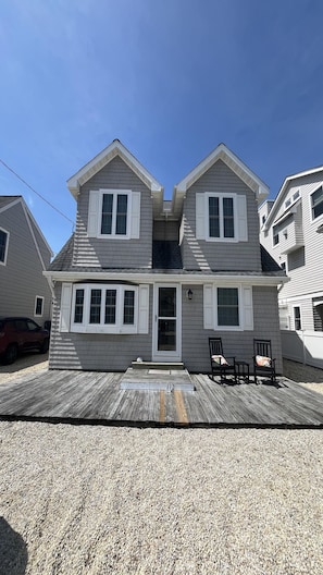 A two-story house with a front porch, a garage, and a driveway. - SPRAY BEACH OCEAN SIDE HOME (Spray Beach)