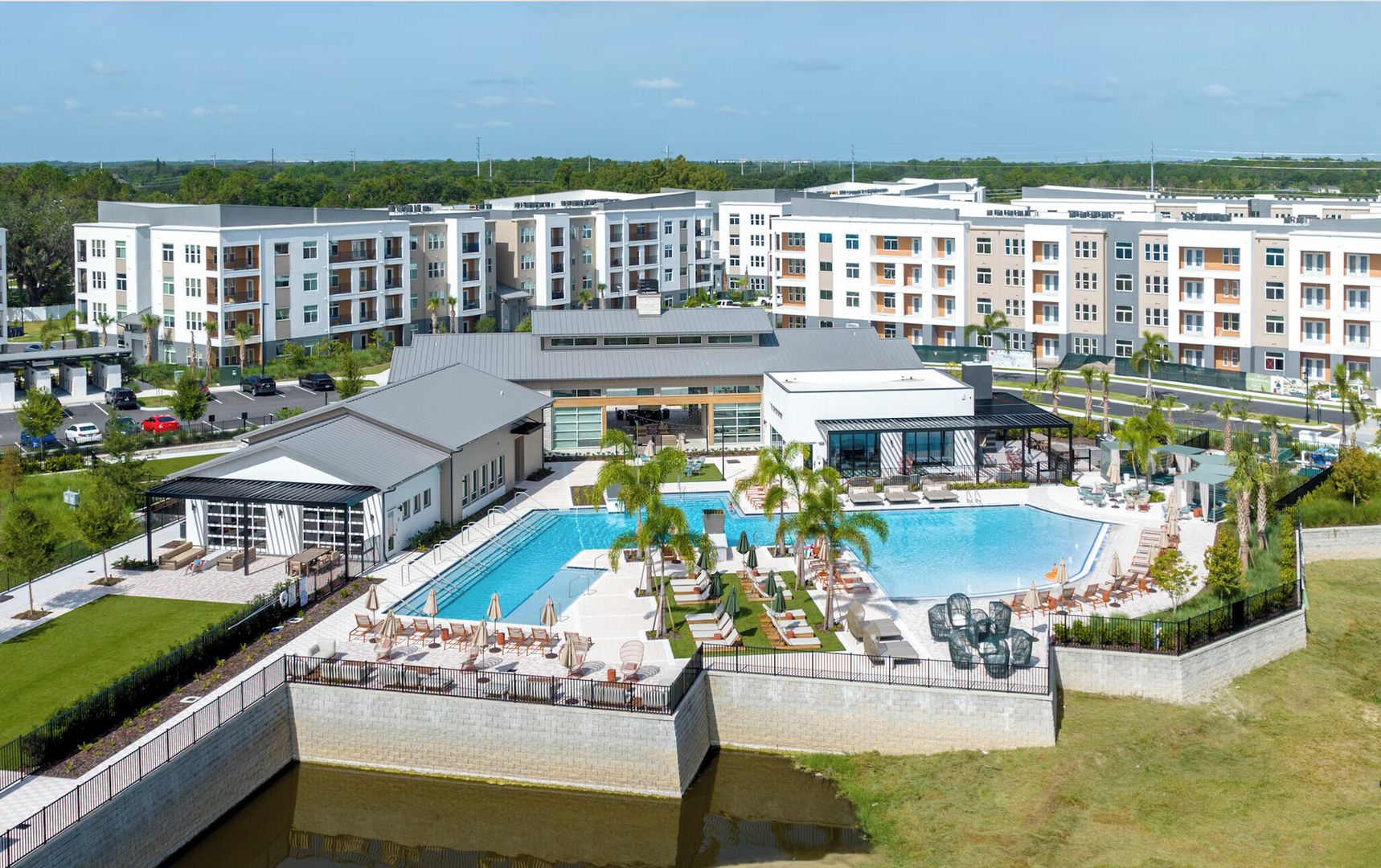 A hotel with multiple buildings, a swimming pool, and outdoor seating areas.