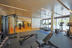 A gym with exercise equipment, benches, and treadmills. - Riviera 59 Studio · Lagoon · Meydan (Dubai)