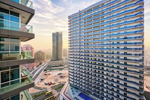 A high-rise building with multiple balconies and a pool area. - Red Residence, Dubai Sports City 1903 (Dubai)