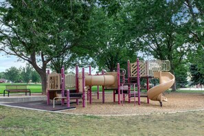 A playground with a slide and climbing structures. - Cozy Duplex by Portal Park | Pet Friendly (Colorado Springs)