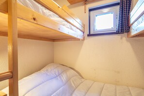 A bunk bed with a window above, a carpeted floor, and a small skylight. - Le Sunset - station de ski accessible à pied (Chamrousse)
