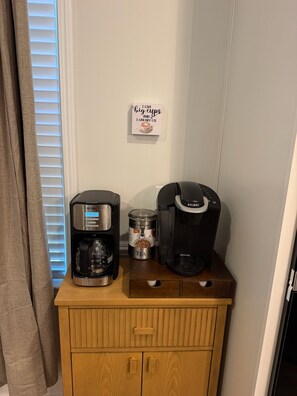 A coffee maker, a Keurig, and a tea container on a wooden cabinet. - 3-bedroom Clemson house in Seneca minutes from school (Seneca)