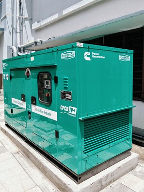 A green industrial power generator with 'Power Generation' and 'Cummins' branding, labeled 'Reliable Inside' and 'CPCB IV+'.