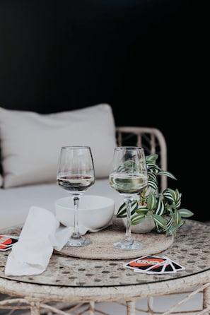 Two wine glasses on a round table with a white napkin and playing cards, a bowl, and a potted plant. - Coastal Hideaway by Lil Blu Stays (Bournemouth, Christchurch and Poole)