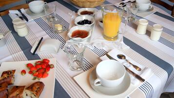 Une table dressée pour le petit-déjeuner, avec une variété d’aliments et de boissons.