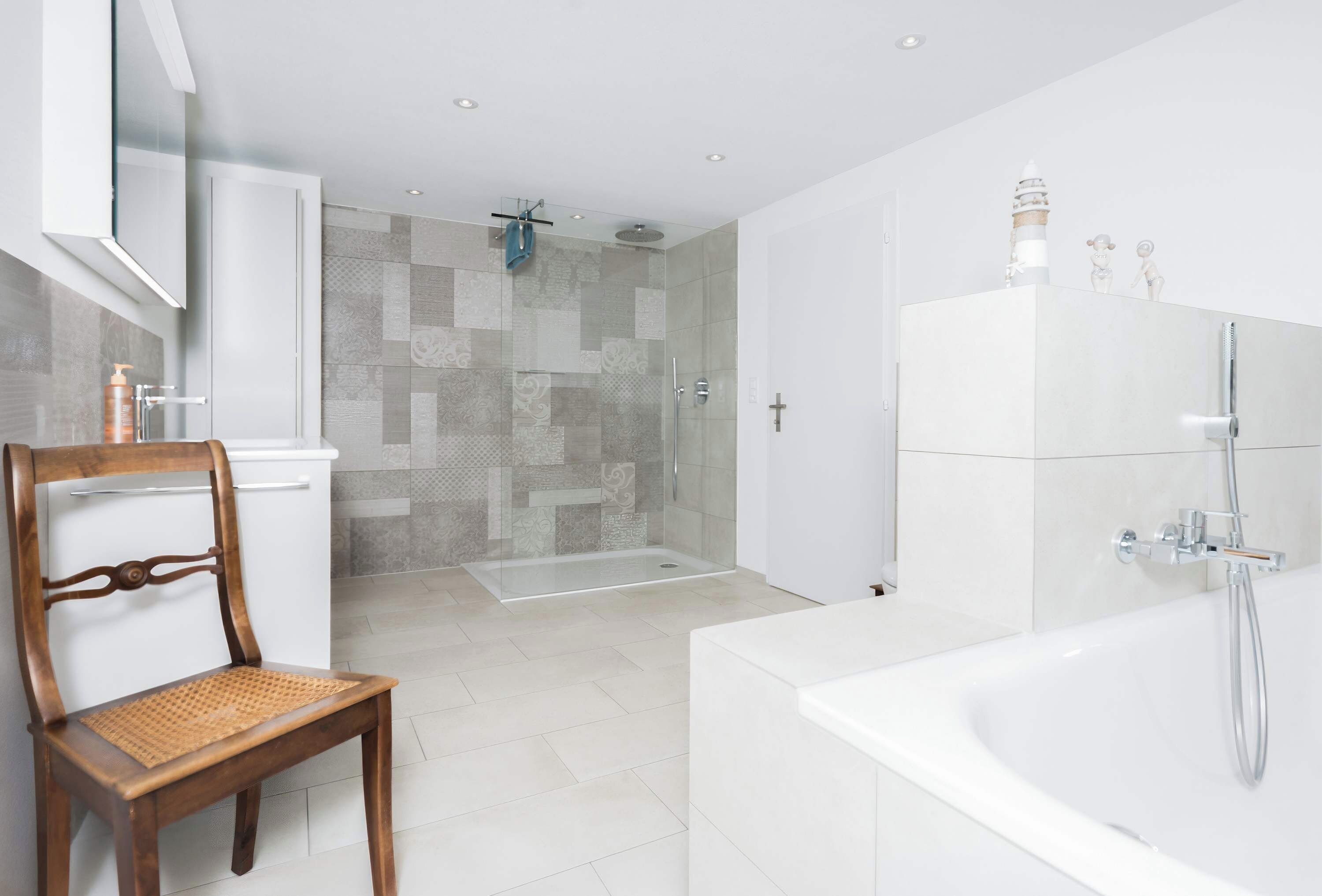A modern bathroom with a bathtub, shower, and a glass-enclosed shower area.