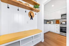 A modern kitchen with white cabinetry, a built-in oven, and a microwave. - Tourmaline Beach Compound - Two Homes, One Getaway (San Diego)