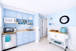 A kitchen with light blue cabinets, a microwave, a toaster, and a coffee maker. - 2 BR/2 BA Beach Front Suite-Kayaks-SUPs-Bikes-Pets (Englewood)