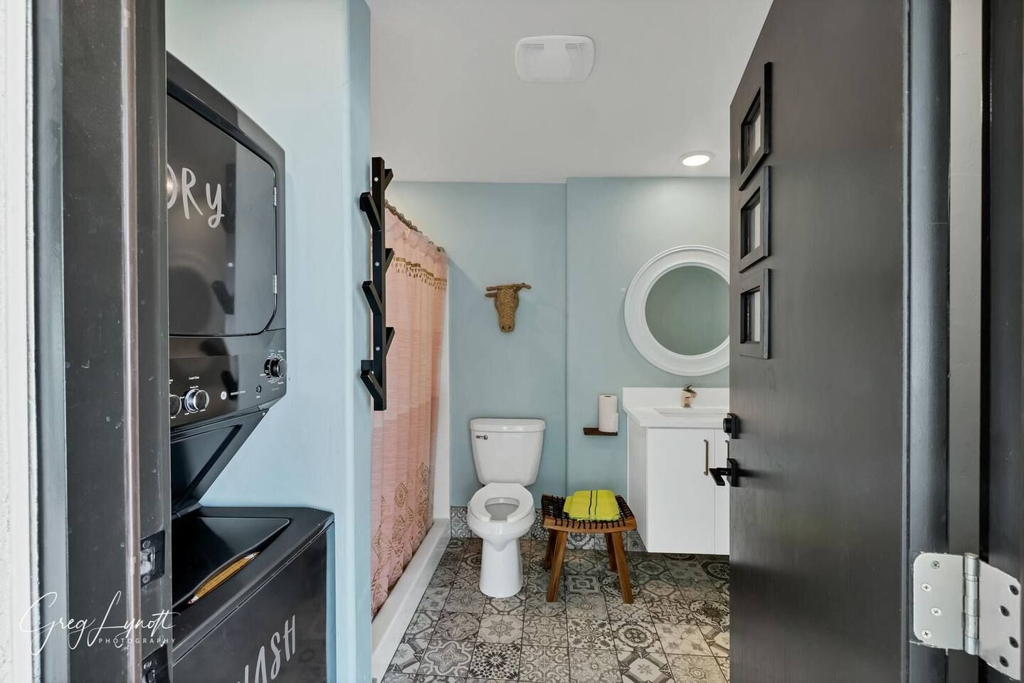 A compact bathroom with a toilet, sink, and a mirror.