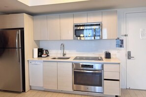 A modern kitchen with stainless steel appliances, a dishwasher, and a built-in oven. - Comfortable Spacious 1BR- Bay View Private balcony (Hallandale Beach)