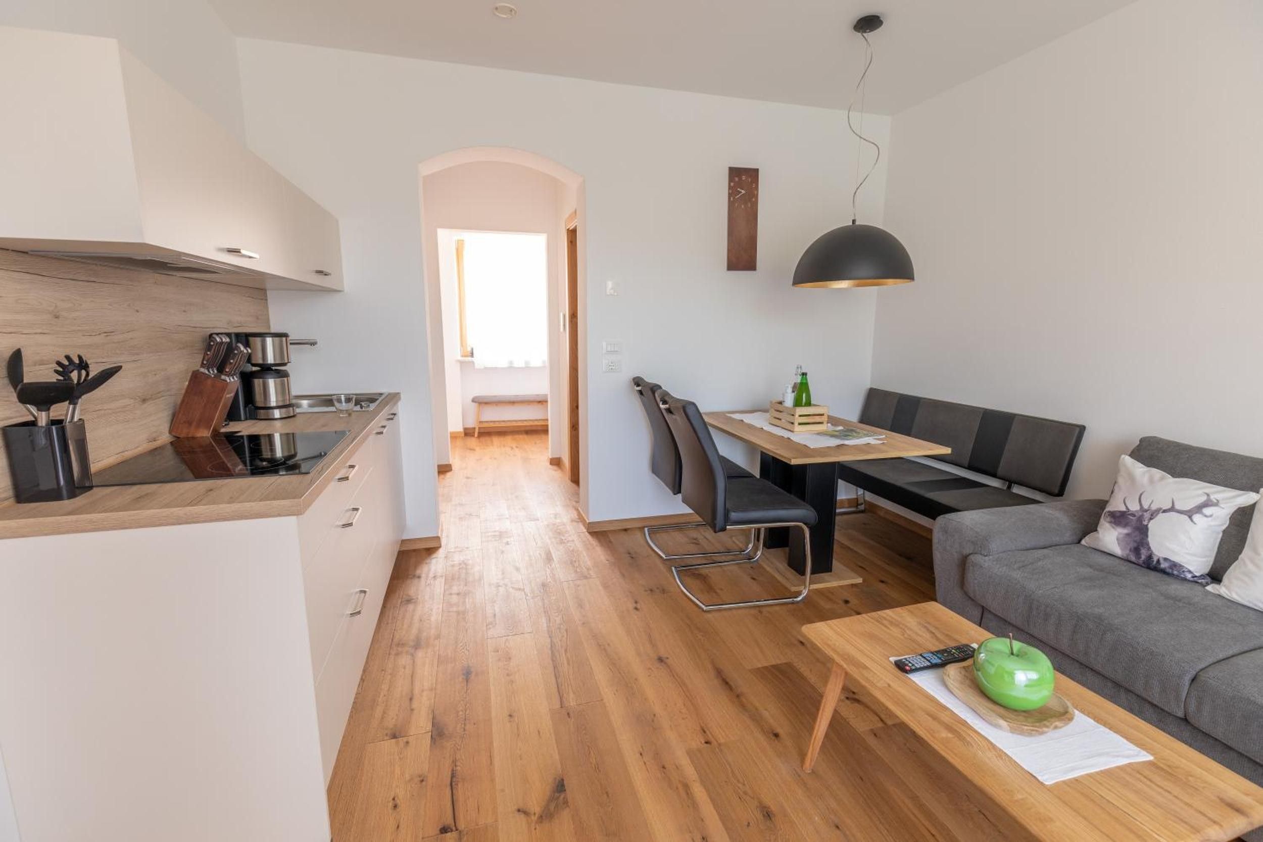 A compact living space with a kitchenette, dining area, and seating area.