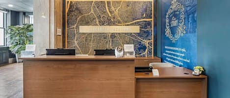 Un comptoir d’accueil avec, en arrière-plan, une carte indiquant les « communautés Bluegreen ».
