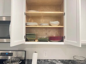 A kitchen with a cabinet containing stacked plates and bowls. - 5BR All One Level | Fenced Yard | Pet Friendly (Richmond)