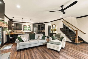 A modern living room with a sofa, armchairs, and a dining area. - Honey's Hideaway I An Exclusive TN River Retreat! (Birchwood)