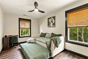 A bedroom with a bed, a desk, and a ceiling fan. - Honey's Hideaway I An Exclusive TN River Retreat! (Birchwood)