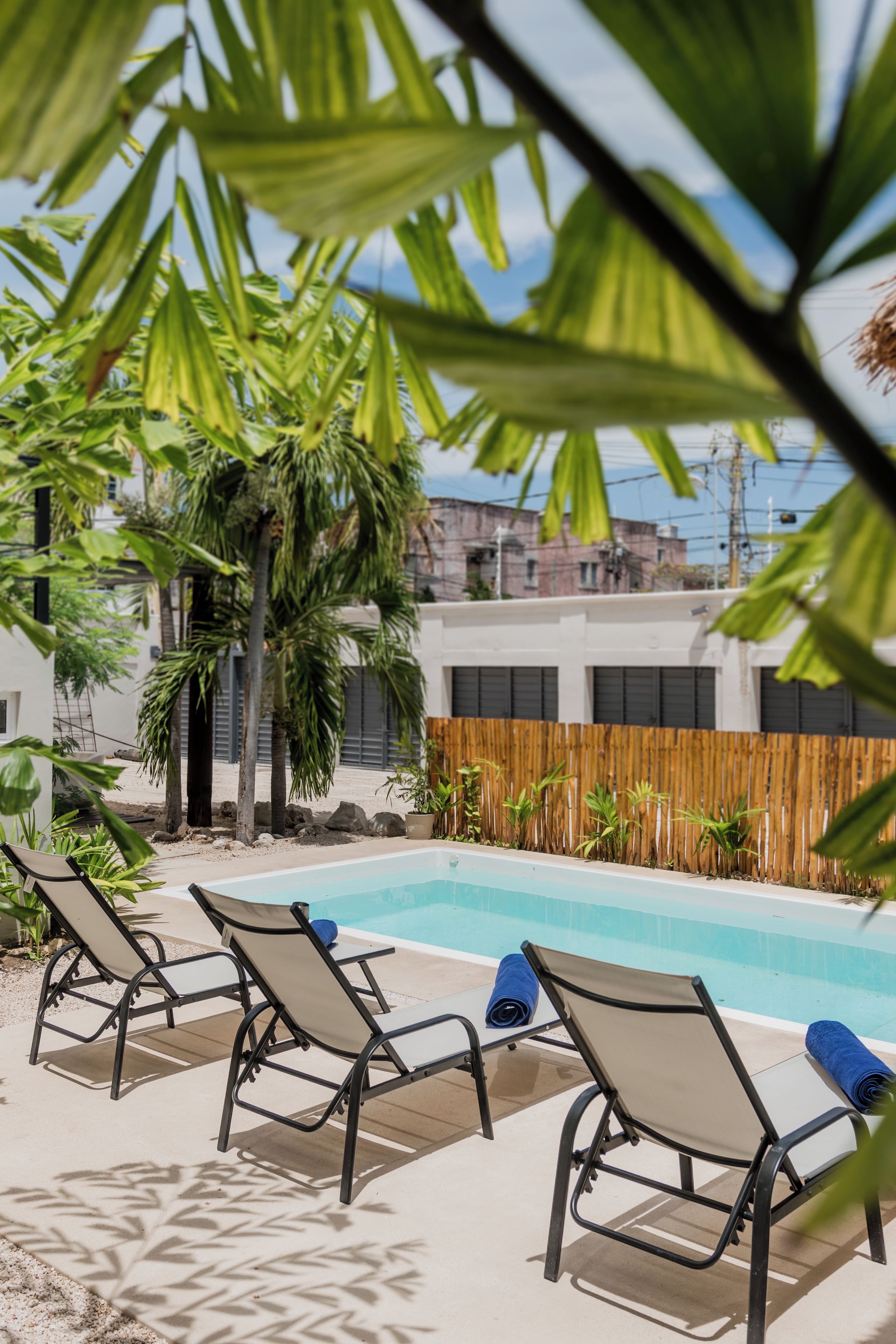 A poolside area with lounge chairs and a pool.