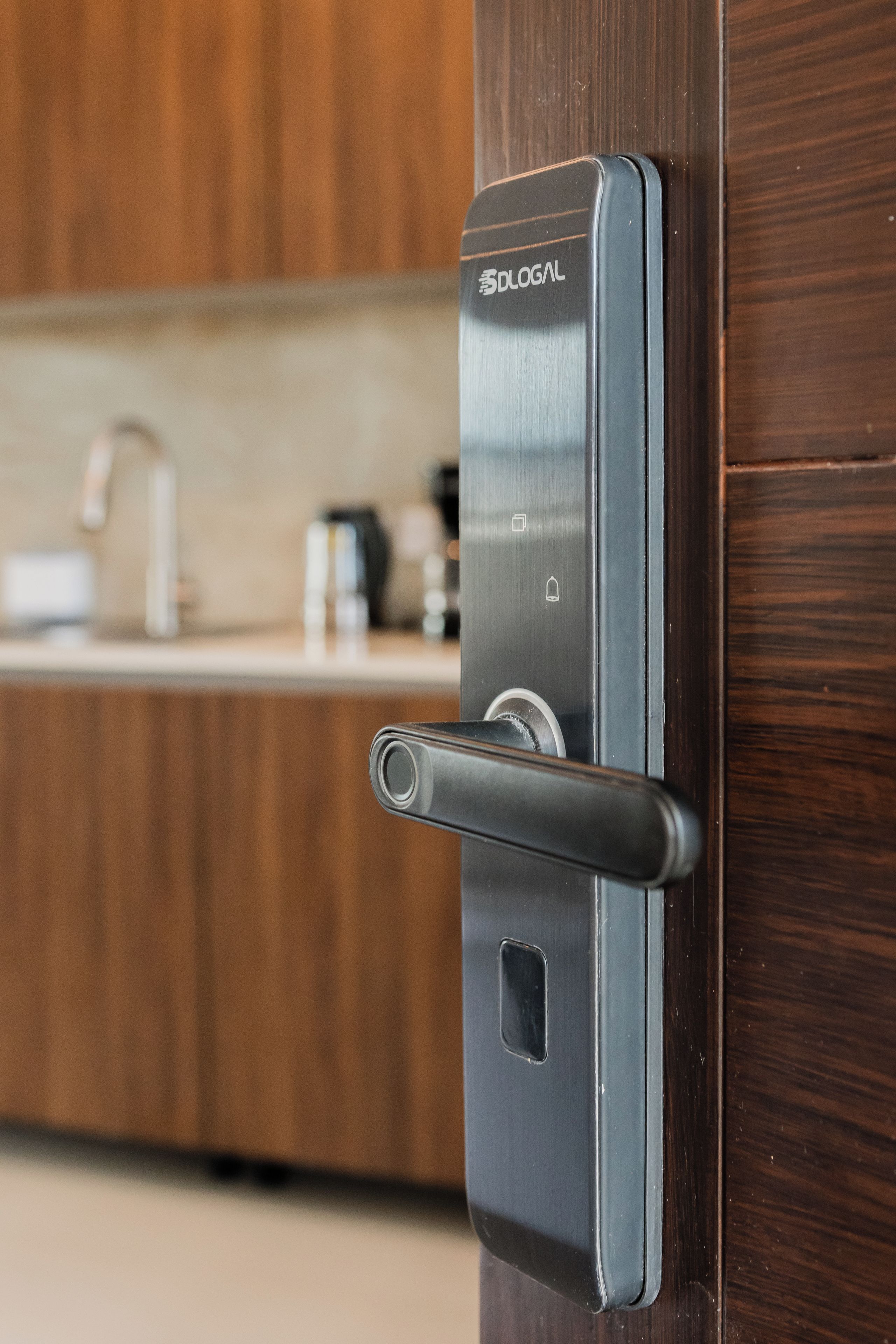A modern door with a handle and a keyhole, part of a wooden interior.