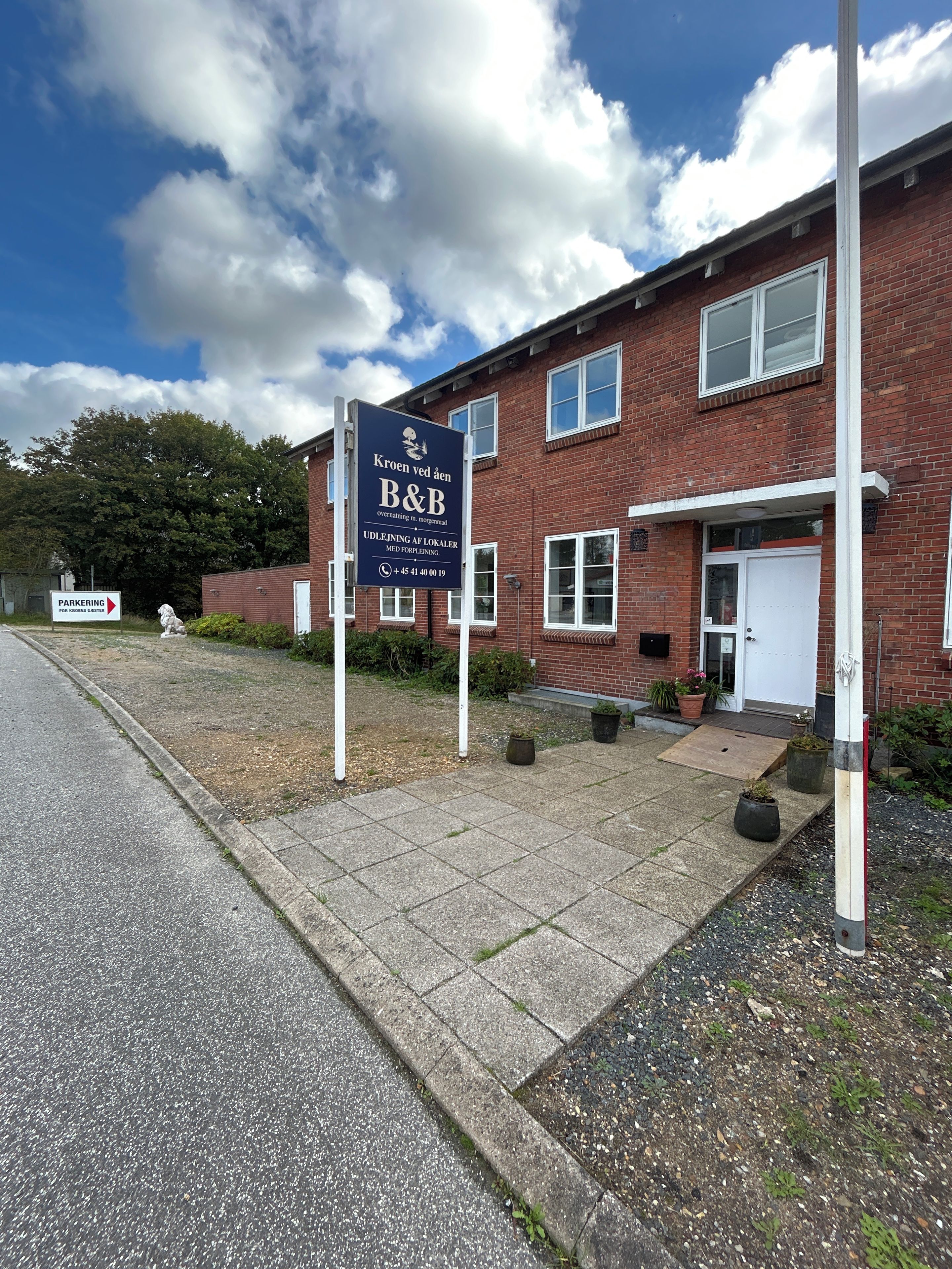 A brick building with a signboard indicating a B&B.