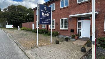 A brick building with a signboard indicating a B&B.