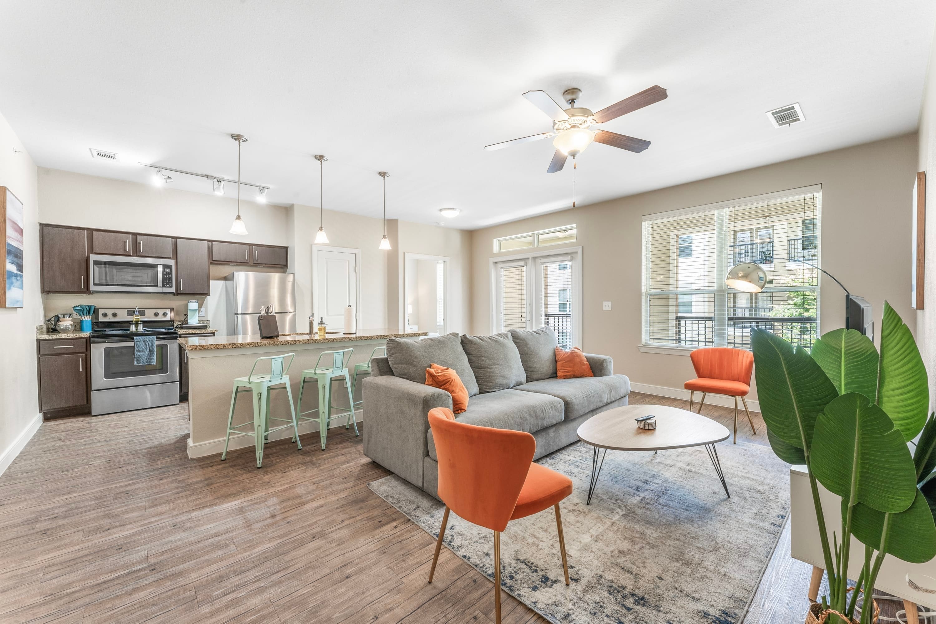 A modern apartment with a kitchen, living area, and a balcony.