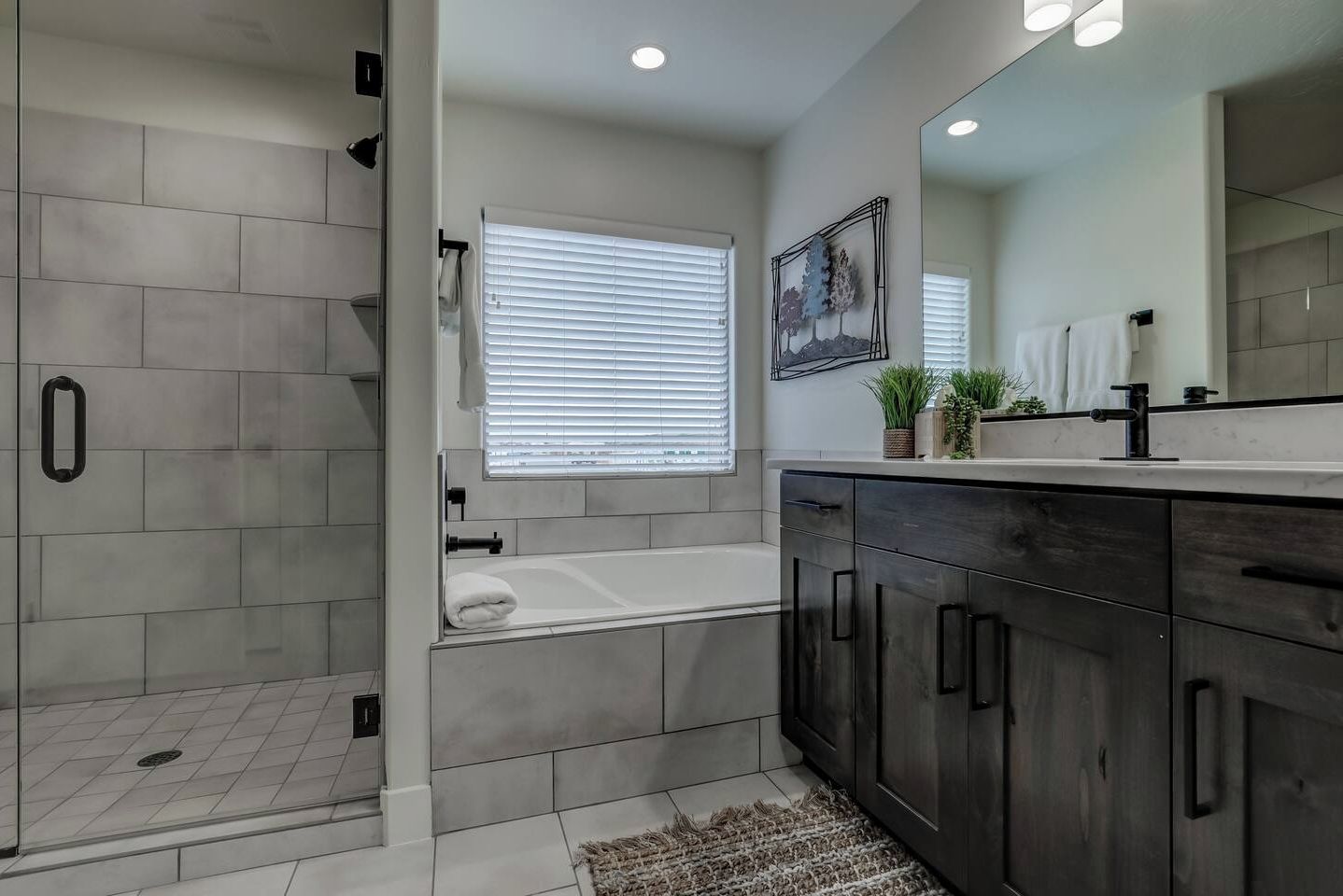 Indulge in the master en-suite bathroom featuring a luxurious soaking tub and spacious walk-in shower.