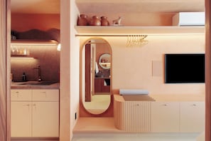 A modern bathroom with a vanity, mirror, and a flat-screen TV mounted on the wall. - MOBE Studios (São Paulo)