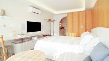 Una camera da letto moderna con un letto grande, una TV a schermo piatto, una scrivania con sedia e un angolo cottura.