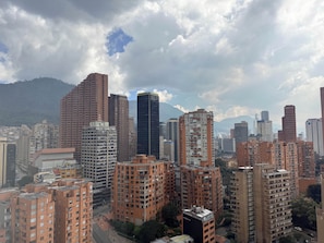 A cityscape with high-rise buildings, including a prominent black skyscraper and several brown residential structures. - Tranquil 1-bedroom apartment in vibrant Bogotá D.C (Bogotá, D.C.)