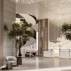 A modern interior with a curved staircase, seating area, and decorative wall panels. - InterContinental Belgrade by IHG (New Belgrade)