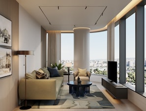 A modern living room with a sofa, coffee table, and a television. - InterContinental Belgrade by IHG (New Belgrade)