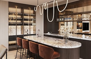 A modern bar area with a marble countertop, wine bottles, and a vase of flowers. - InterContinental Belgrade by IHG (New Belgrade)
