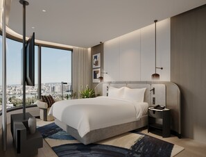 Un dormitorio moderno con una cama grande, vistas a la ciudad y decoración contemporánea.