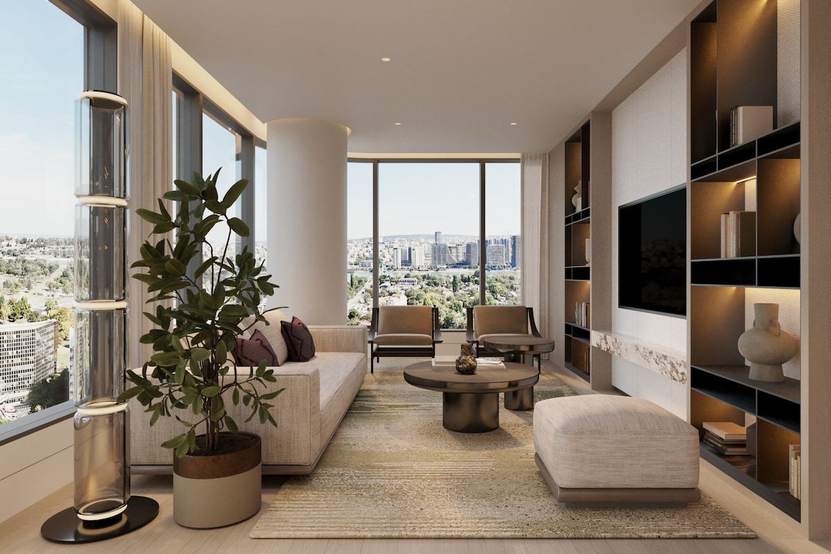 Una sala de estar moderna con vistas a la ciudad, que incluye un sofá, sillas, una mesa de centro y una estantería.