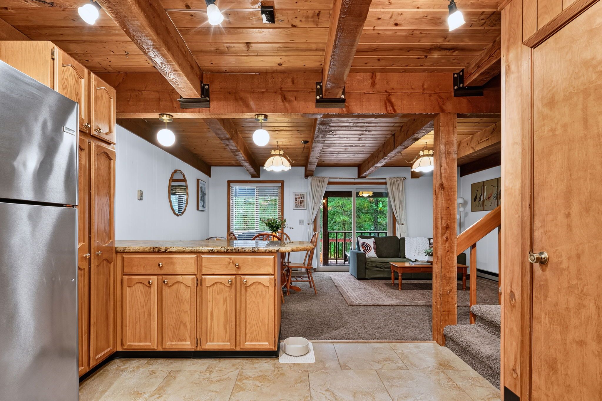 A wooden interior with a kitchen, dining area, and living room.