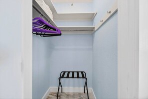 A small, enclosed space with a black metal rack, a white shelf, and a purple hanger. - SonnenHaus - Private Pool - 5 min Walk to Beach (Redington Beach)