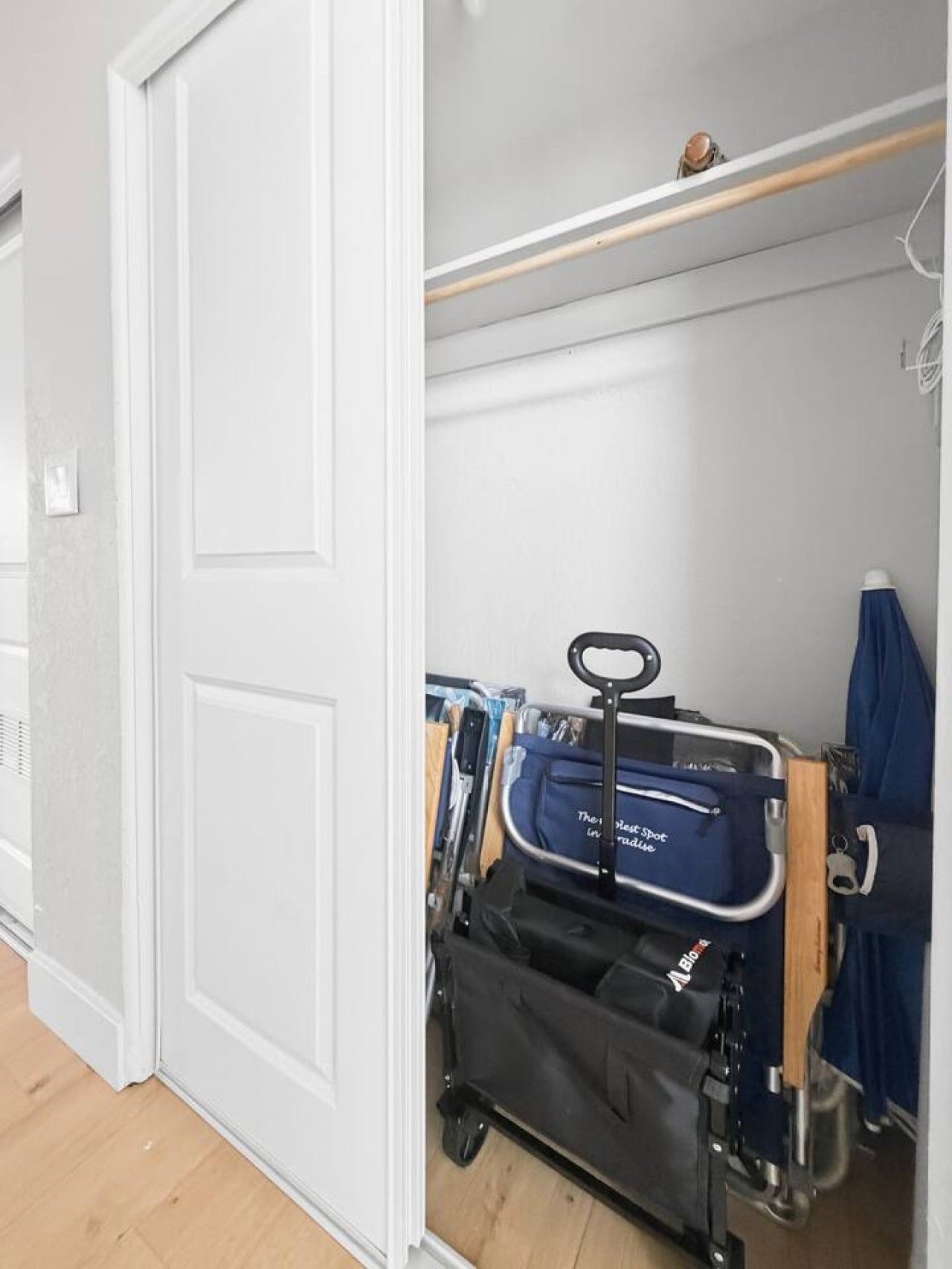 A room with a white door, a wheelchair, and a blue bag with 'The Sleep Spot' text.