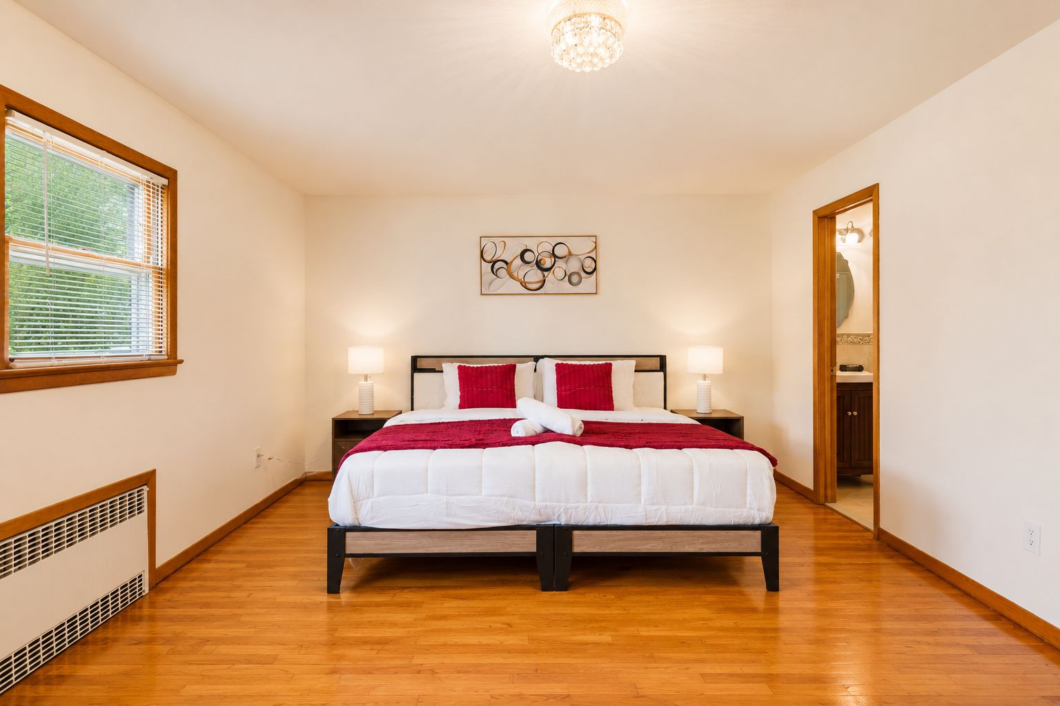 Spacious bedroom with hardwood floors and ensuite bath access