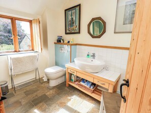 A bathroom with a toilet, sink, and window. - Hart Head Farm (Ambleside)