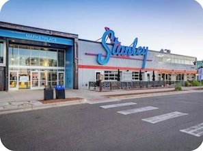 A storefront with a large sign reading 'Stanley' and a 'MARKETPLACE' sign above the entrance. - Cozy Home with Large Yard (Aurora)