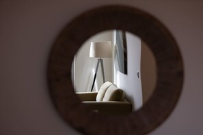 A circular mirror reflecting a room with a lamp and a sofa. - Birmingham City Retreat No 154 (Birmingham)