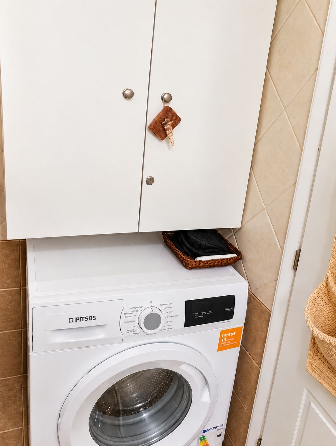 A white washing machine with a control panel and a label indicating energy efficiency.