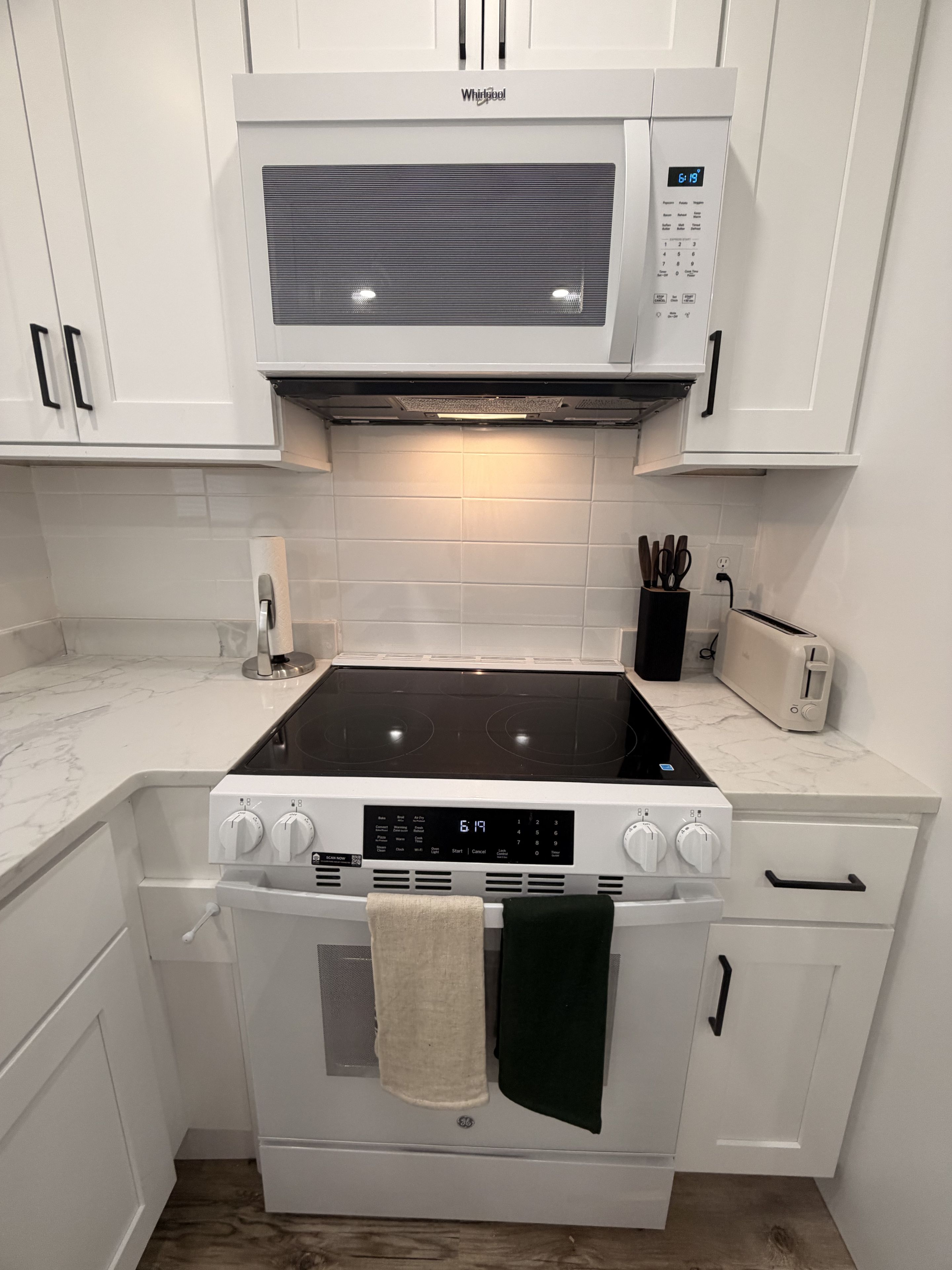 A kitchen with a built-in microwave, stove, and oven.
