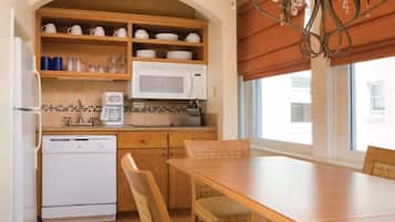 Dining & Kitchenette • Wood table under the chandelier