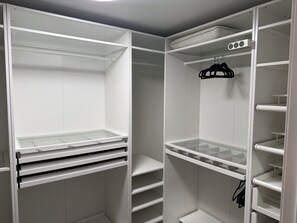 A walk-in closet with open shelves, hanging space, and a shoe rack. - Open 2 Bedroom Condo Floorplan with RV Parking near University of Notre Dame (Niles)