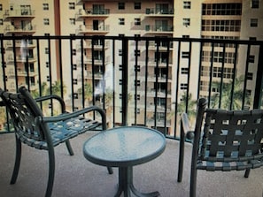 A balcony with a metal railing, two chairs, and a small round table. - Club Wyndham Palm-Aire 2 Bedroom, 2 Bath - Pampering Encouraged! (Pompano Beach)