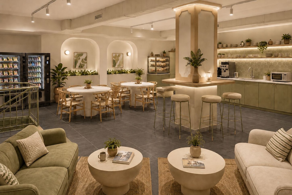 Un interior moderno con barra, asientos y una kitchenette.