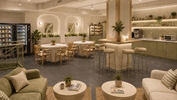 Un intérieur moderne comprenant un bar, des espaces pour s’asseoir et une petite cuisine.