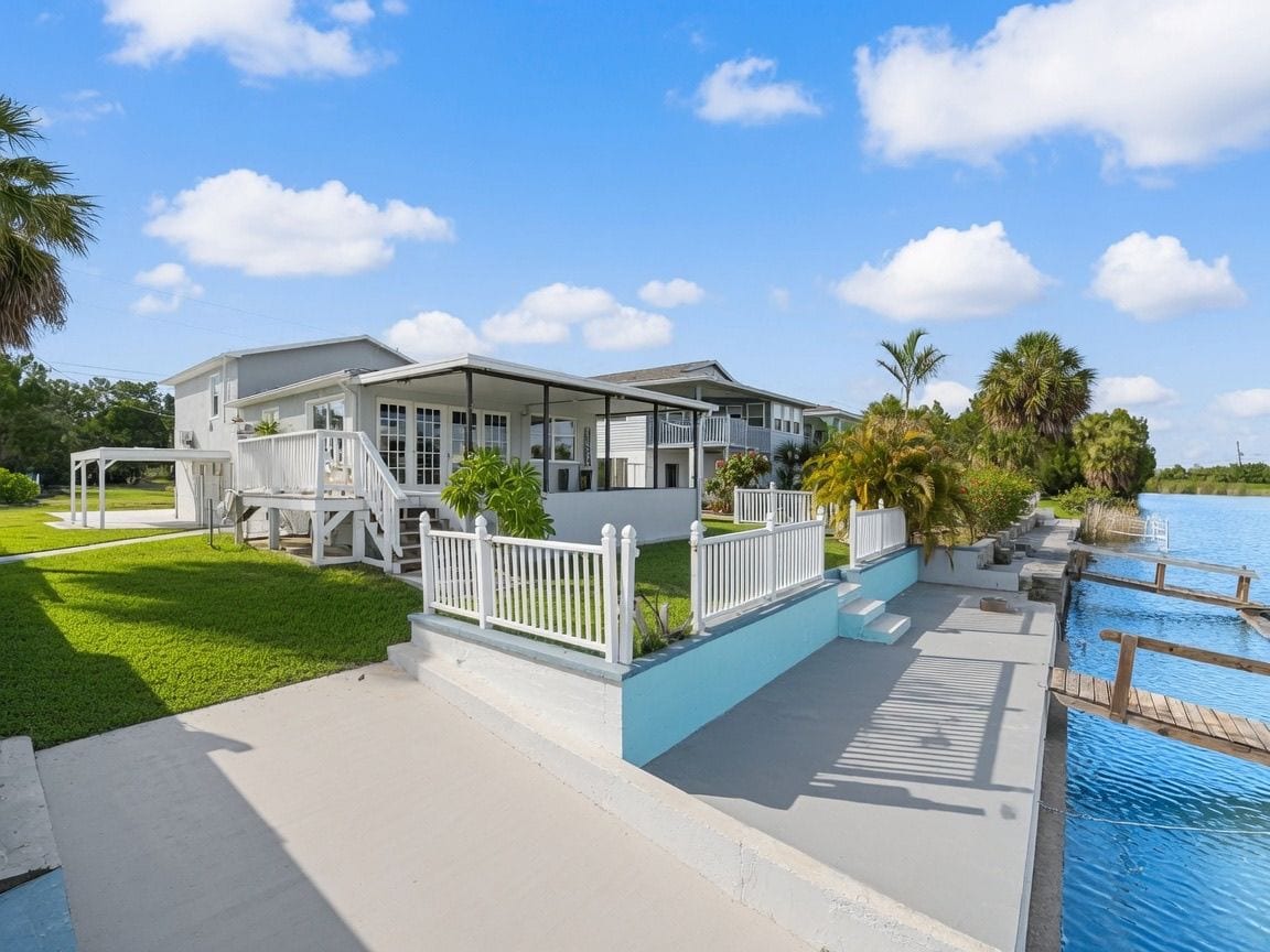 A two-story building with a covered porch and a swimming pool.