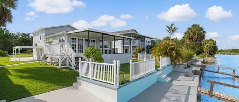 A two-story building with a covered porch and a swimming pool.